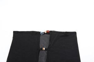 Macro view of semi-transparent black mesh fabric with decorative beaded ties detail