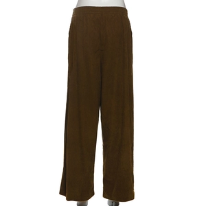 Detail view of high waist brown corduroy wide leg trousers with textured vertical stripes