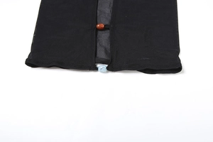 Detail view of sheer black mesh fabric with unique wood and blue bead closure