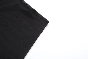 Detail shot of black sheer mesh fabric with high-quality overlock stitching and texture