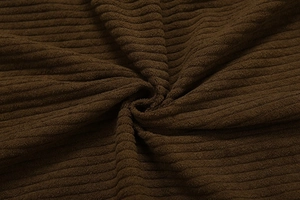 Detailed macro view of dark brown corduroy fabric texture with vertical ribbed pattern