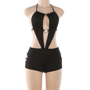 Detail of black halter romper showing deep V-neck with silver ring and side hollow cutouts