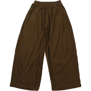 Detail of high waist wide leg corduroy trousers in deep brown with elastic waistband