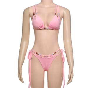 Detailed view of pink string bikini set with decorative brown and light blue beads