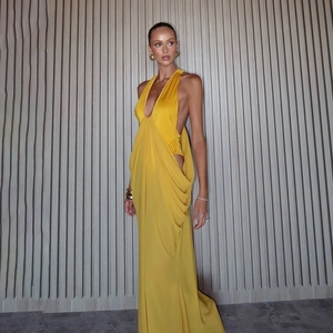 Elegant ginger yellow satin maxi dress with deep V-neck and ruched waist details