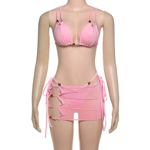 Detail of pink three-piece floral bikini set with beaded mesh cover-up skirt on mannequin