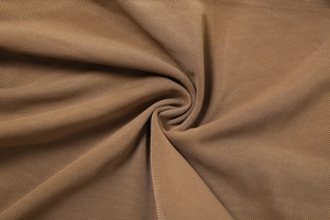 Detailed macro view of camel mesh fabric with soft pleated texture and breathable mesh pattern
