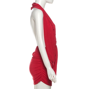 Detail of red halter backless dress with side slit and gathered ruched fabric textures
