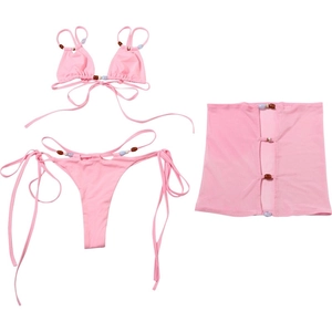 Detailed view of pink three-piece bikini set featuring colorful beads and matching mini skirt