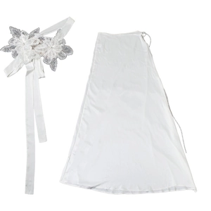 Close-up of white satin long skirt with detailed lace floral belt and elegant silk ribbons