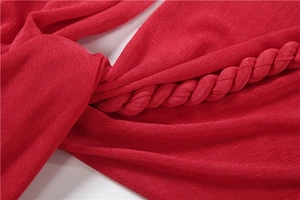 Detail of red ribbed knit halter strap featuring a sophisticated twisted texture design