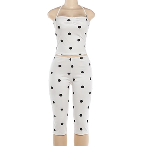 Detail of polka dot halter top and high waist capri pants set on a mannequin
