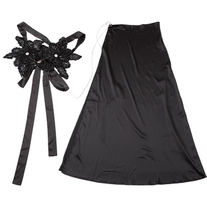 Detail of black satin maxi skirt with floral sequin applique and delicate metal chain