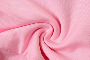 Close-up of pink ribbed fabric showing soft texture and premium weave for bikini sets