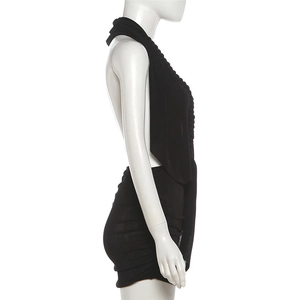 Detail of black halter backless mini dress featuring side ruched pleated stitching details