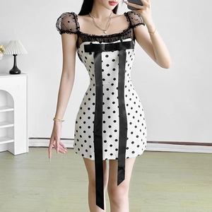 Detail of a polka dot mini dress with a large satin bow and mesh spliced puff sleeves