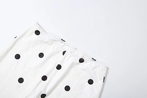 Detail of high-elasticity fabric and elastic waistband on polka dot pants with wash label
