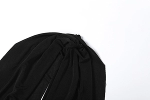Detailed macro view of black twist headband fabric with elastic knit texture and knot