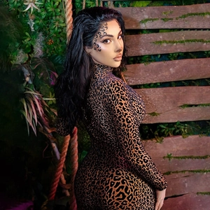 Detail of high neck long sleeve bodysuit with leopard print pattern in a jungle setting
