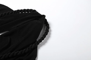 Detail of black sexy halter mini dress showing thick twisted rope and knit texture
