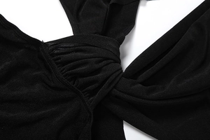 Detail view of a black mini dress featuring a central cross-knot design and ribbed knit fabric