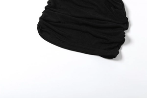 Detail shot of the black dress featuring elastic ruching and high-quality hem stitching