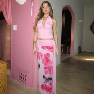 Close-up of pink halter top and floral maxi skirt with vibrant floral pattern