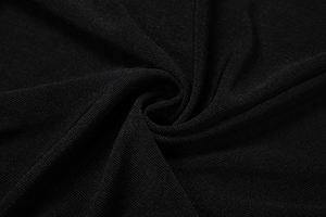 Macro shot of black ribbed knit fabric texture with vertical striped pattern and high elasticity