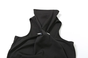Detailed view of black ribbed high neck top featuring a metallic spike buckle and twist design