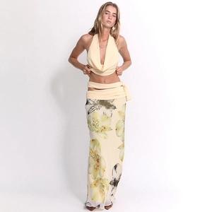 Detail of floral printed maxi skirt and halter neck top set in soft yellow chiffon