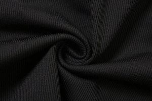 Macro close-up showing the premium black ribbed knit fabric texture with vertical lines