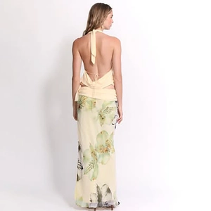 Detail of light yellow floral halter neck top and long skirt set with an open back design