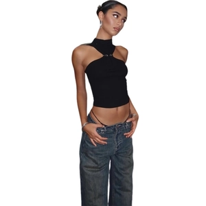 Detail of high neck black crop top with metal buckle and cutout on elastic knit fabric