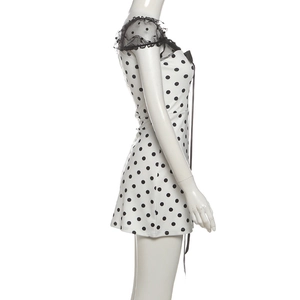 Detailed side view of polka dot mini dress with black mesh ruffles and lace stitching