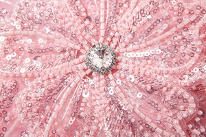 Close-up of pink handmade floral beadwork with sequins and sparkling rhinestones
