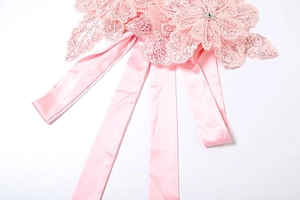 Detail of pink sequin floral appliqué with rhinestones and silky satin ribbons