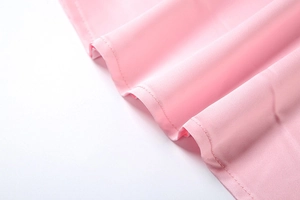 Close-up of pink sequin fabric showing fine stitching and soft chiffon texture