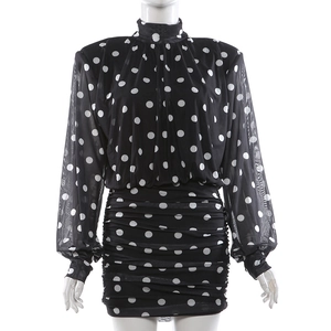 Detail of long sleeve polka dot mini dress with ruched body and semi-sheer mesh sleeves