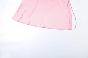 Detailed view of pink satin maxi skirt with high side slit and sparkling rhinestone chain