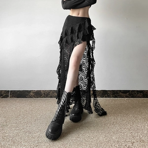 Close-up of black lace layered skirt showing hollow floral patterns and high slit detail