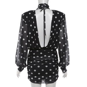 Detailed view of polka dot ruched mini dress with sheer mesh long sleeves and open back