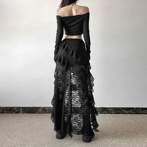 Detail of sheer floral lace skirt with asymmetrical ruffles and long sleeves top