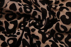 Close-up of leopard print sheer mesh fabric with black flocking and texture detail