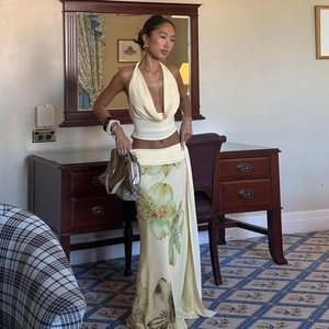 Detail of elegant backless halter top and floral maxi skirt set in silk-like fabric