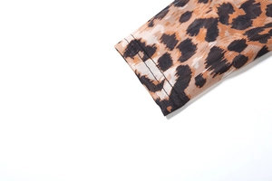 Close-up of leopard print mesh sleeve showing breathable fabric and double-stitch cuff detail