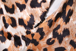 Close-up of leopard print fabric with a black invisible teardrop zipper detail