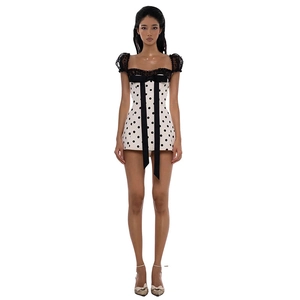 Polka dot mini dress with lace trim, puff sleeves, and a black decorative bow tie