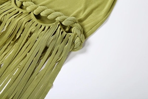 Detail of hand-woven olive green braid and long fringes on a backless summer dress