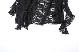 Detailed macro view of black floral lace fabric with delicate scalloped irregular hemline