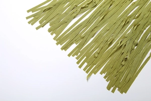 Detailed close-up of olive green woven fringe tassels with elegant braided textile texture